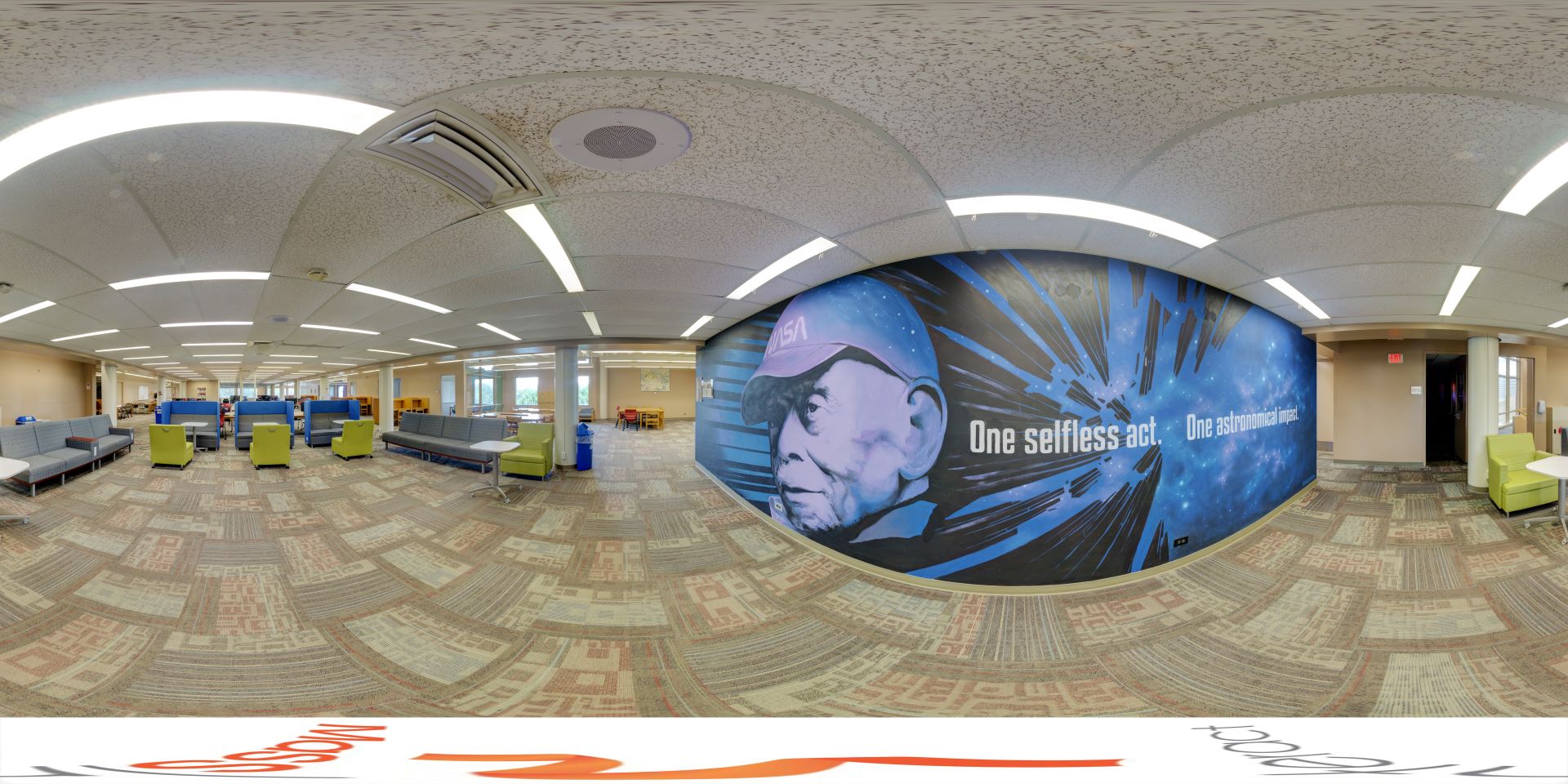 Panoramic view of the third floor in Evans Library, featuring an inspiring mural with the quote 'One selfless act. One astronomical impact.' alongside casual seating and study areas.